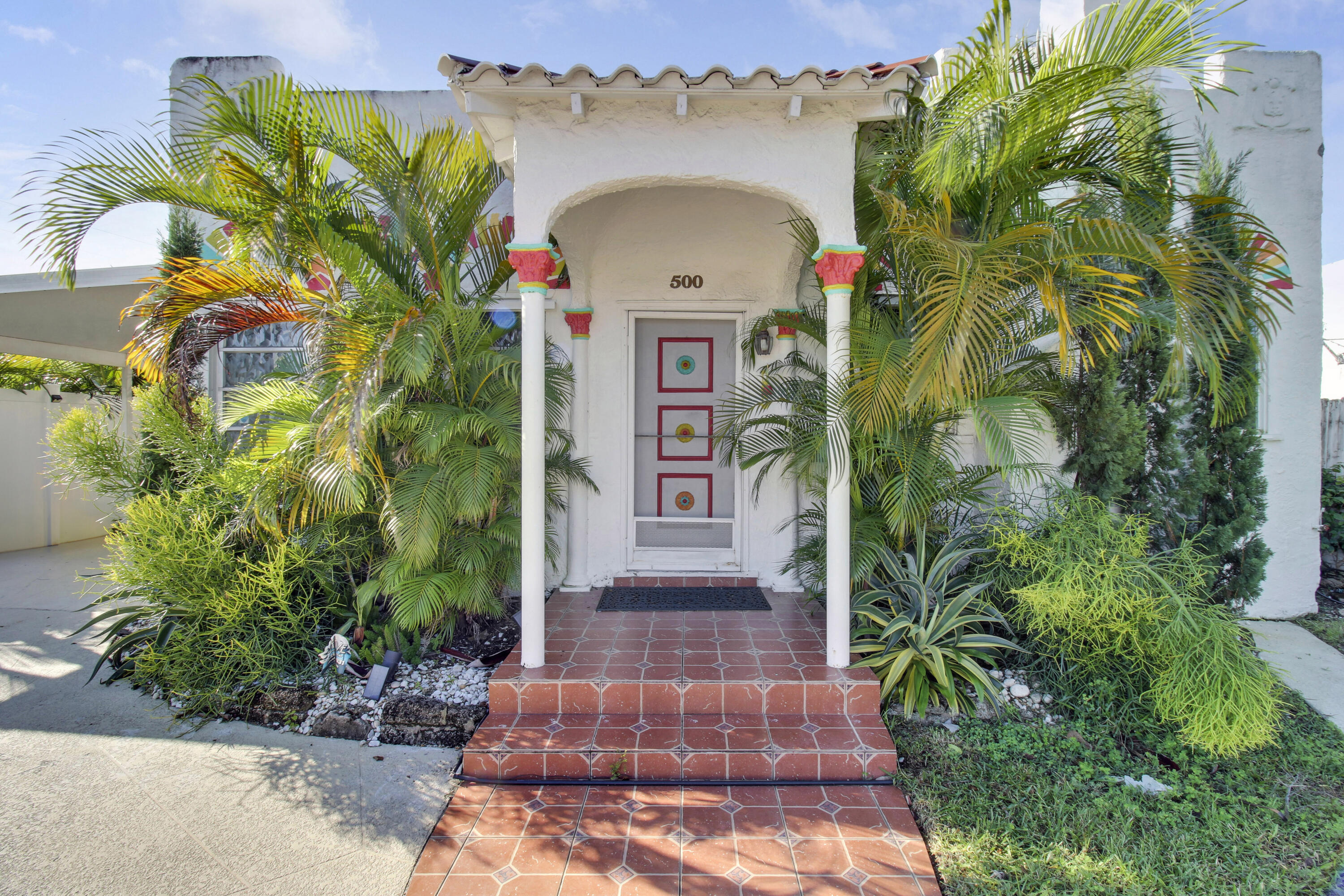 a front view of a house with a garden