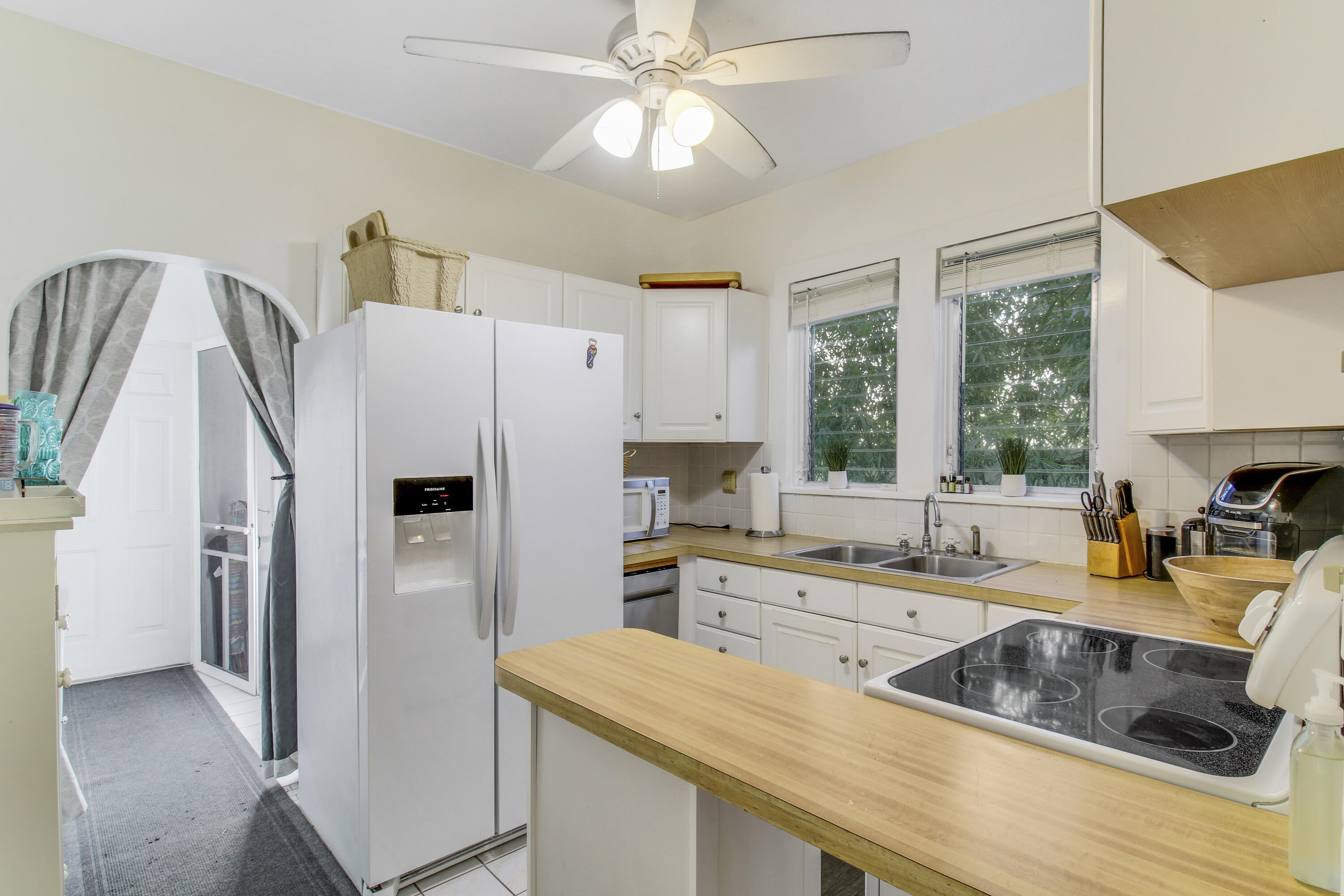 500 Mayflower Road West Palm Beach, FL 33405 - Photo 8 of 22 a kitchen that has a cabinets a sink and a stove