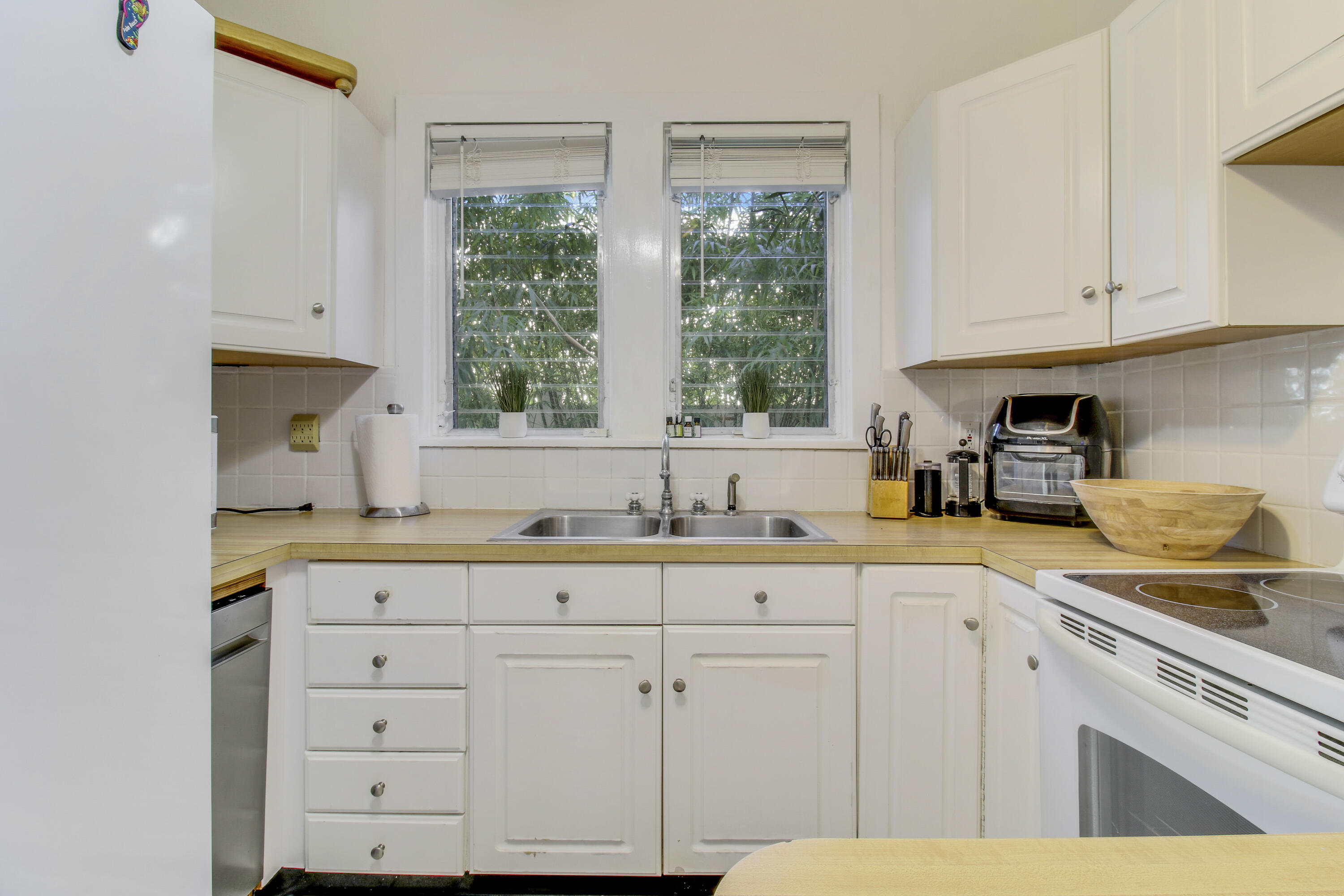 500 Mayflower Road West Palm Beach, FL 33405 - Photo 9 of 22 a kitchen with granite countertop white cabinets and a window