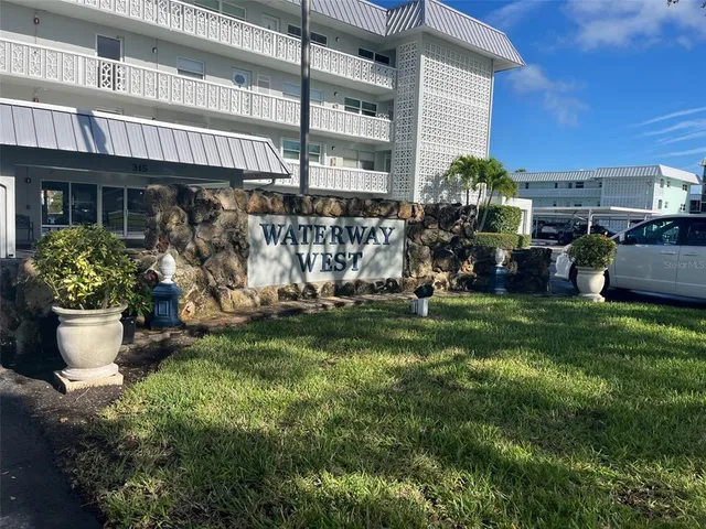 a front view of a house with a garden and patio