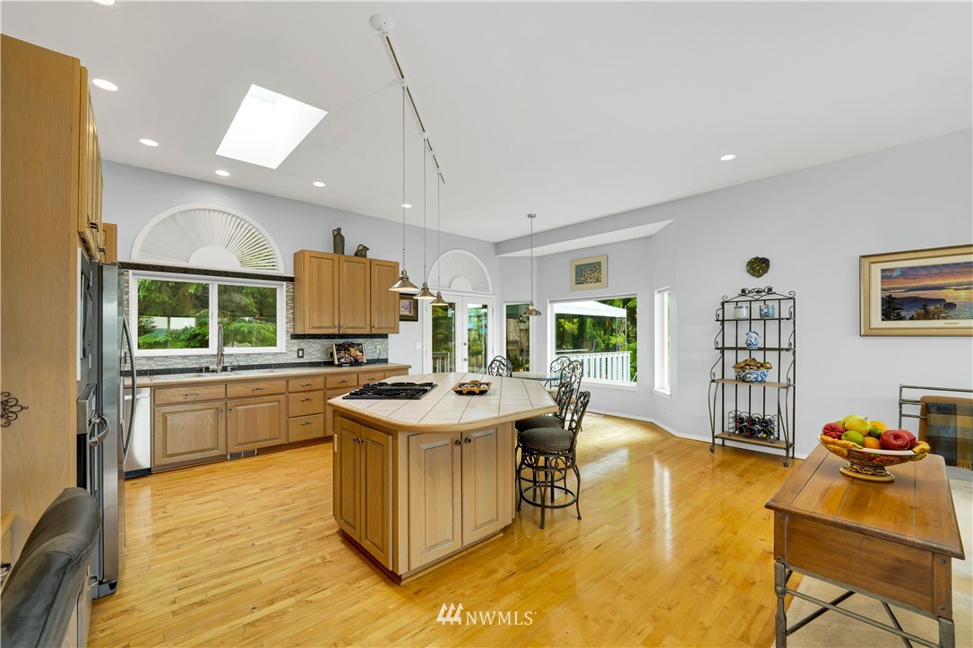 4191 Islander Way Anacortes, WA 98221 - Photo 12 of 40 a kitchen with a stove a refrigerator and wooden cabinets