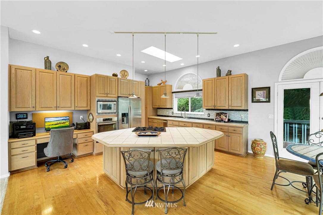 4191 Islander Way Anacortes, WA 98221 - Photo 13 of 40 a large kitchen with a table and chairs in it