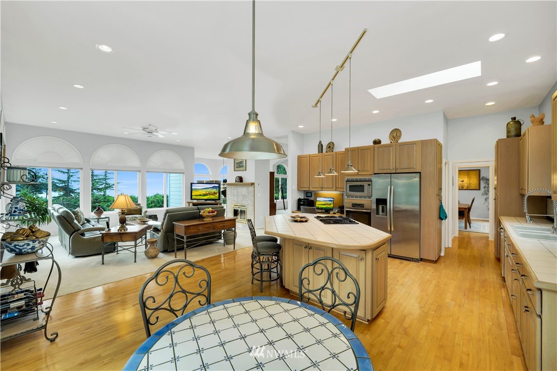 4191 Islander Way Anacortes, WA 98221 - Photo 15 of 40 a view of a dining room with furniture a chandelier and wooden floor