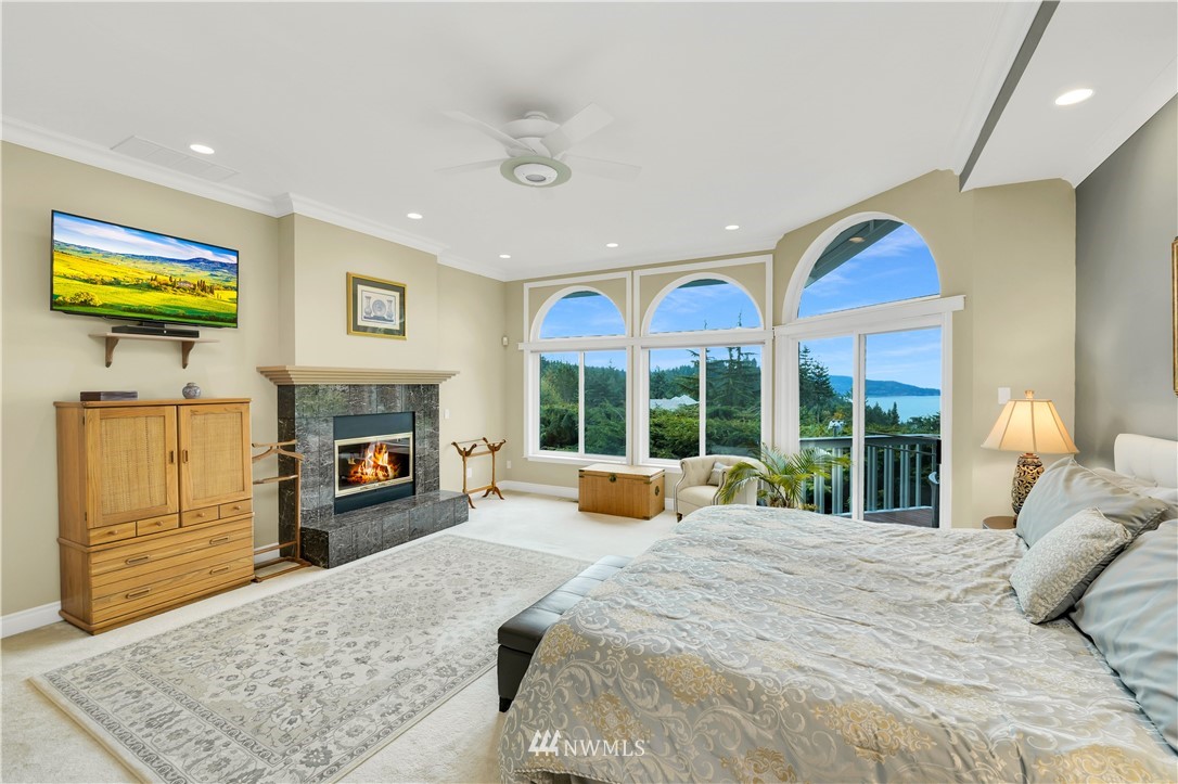 4191 Islander Way Anacortes, WA 98221 - Photo 18 of 40 a bedroom with a bed and a flat screen tv