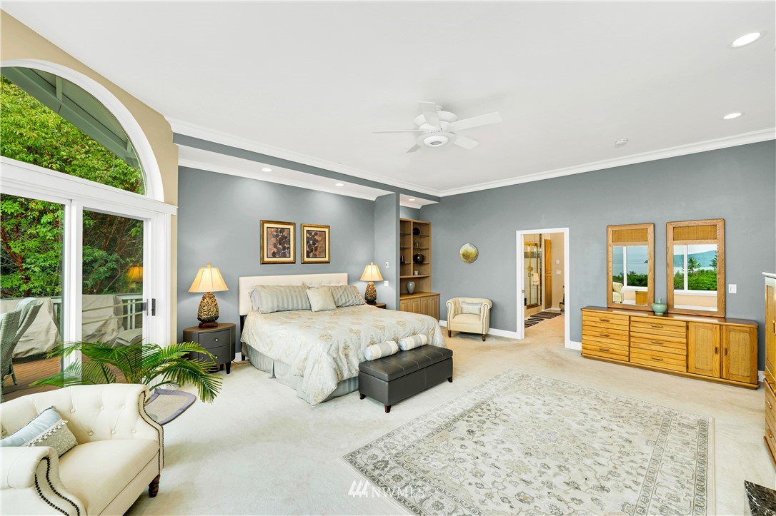 4191 Islander Way Anacortes, WA 98221 - Photo 19 of 40 a spacious bedroom with a large bed and windows