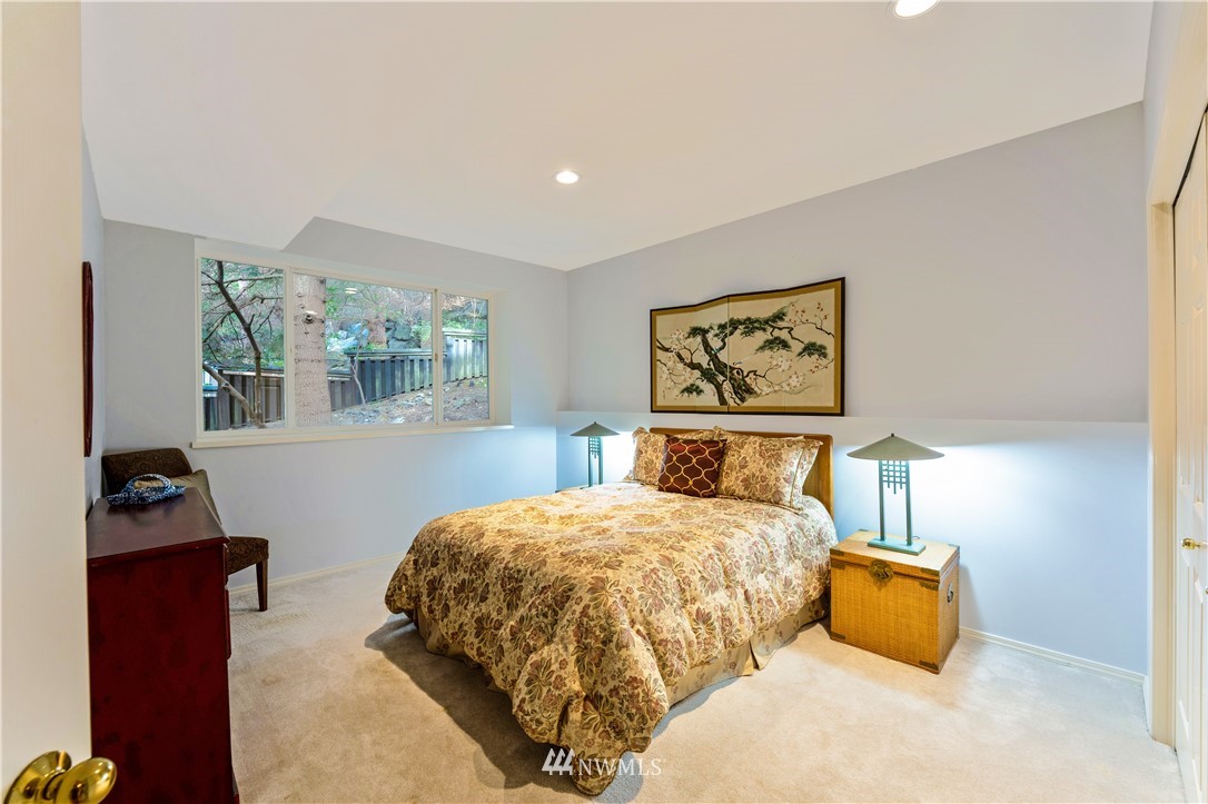 4191 Islander Way Anacortes, WA 98221 - Photo 27 of 40 a bedroom with a bed and wooden floor