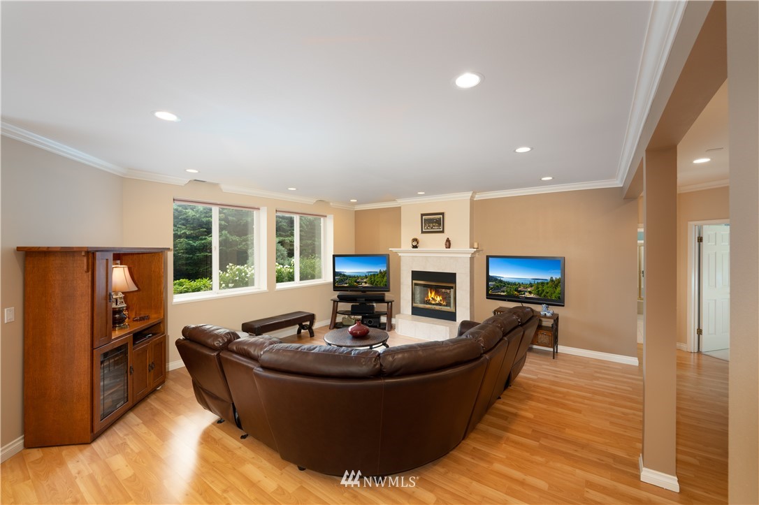 4191 Islander Way Anacortes, WA 98221 - Photo 33 of 40 a living room with fireplace furniture and a large window