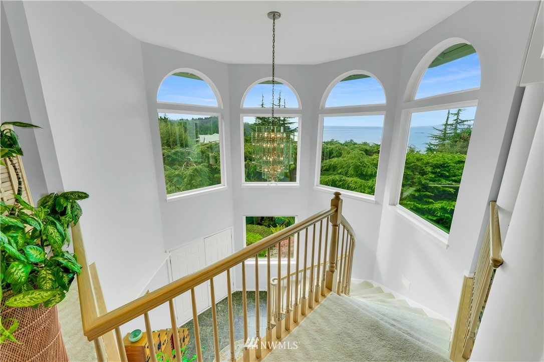 4191 Islander Way Anacortes, WA 98221 - Photo 36 of 40 a view of a room with large windows and a chandelier