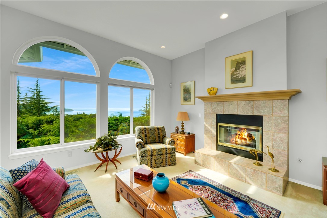 4191 Islander Way Anacortes, WA 98221 - Photo 5 of 40 a living room with furniture fireplace and a large window