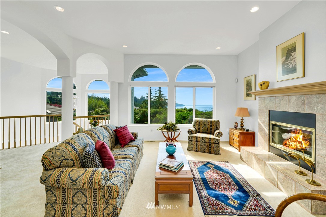4191 Islander Way Anacortes, WA 98221 - Photo 6 of 40 a living room with furniture fireplace and a large window