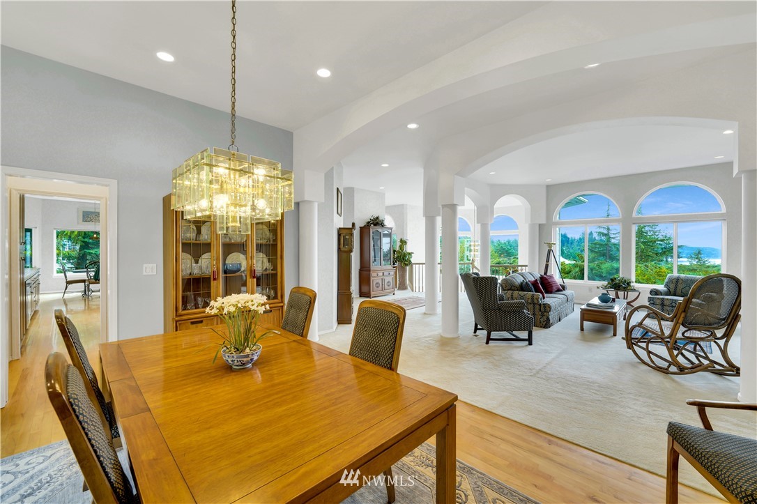4191 Islander Way Anacortes, WA 98221 - Photo 9 of 40 a view of a dining room with furniture chandelier and wooden floor