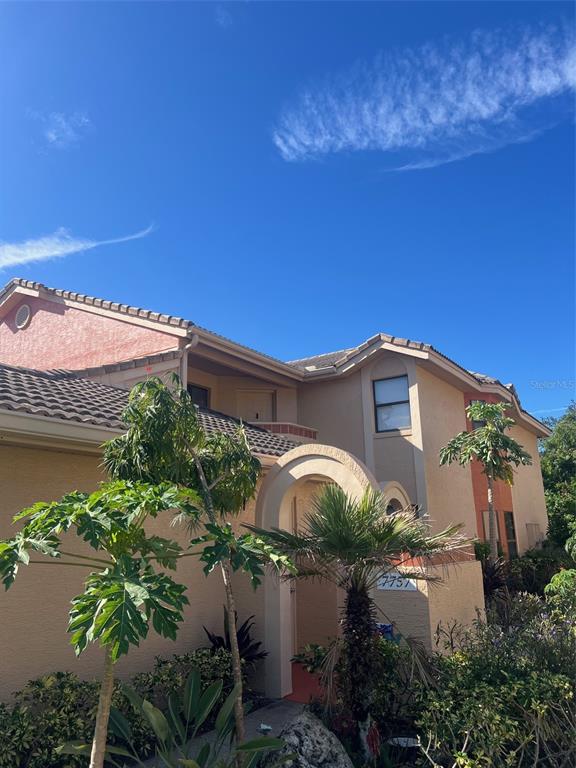 7757 Sugar Bend Drive, Unit 7757 Orlando, FL 32819 - Photo 1 of 30 a front view of a house with a yard