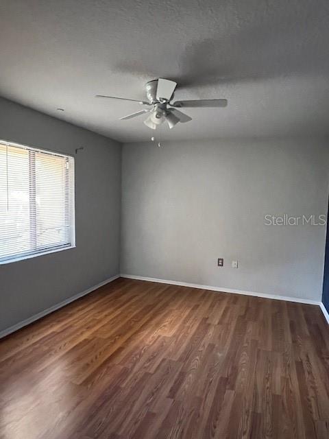 7757 Sugar Bend Drive, Unit 7757 Orlando, FL 32819 - Photo 21 of 30 an empty room with wooden floor fan and windows