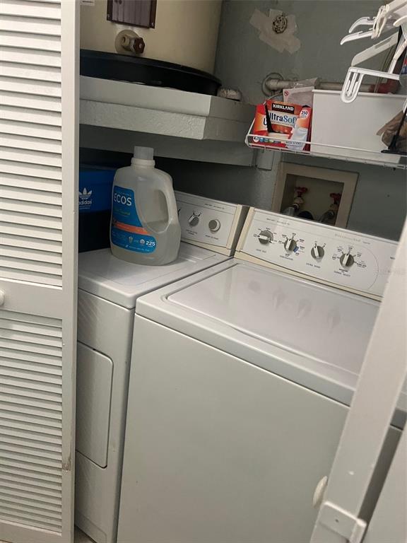 7757 Sugar Bend Drive, Unit 7757 Orlando, FL 32819 - Photo 24 of 30 a utility room with dryer and washer