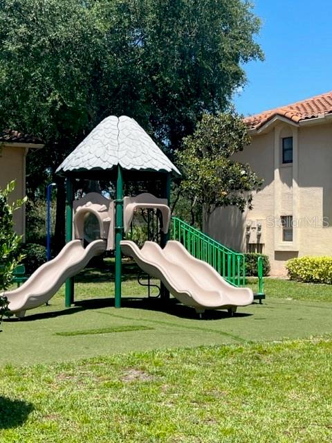 7757 Sugar Bend Drive, Unit 7757 Orlando, FL 32819 - Photo 25 of 30 a view of a house with backyard and trees