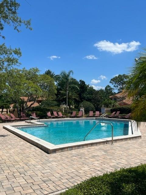 7757 Sugar Bend Drive, Unit 7757 Orlando, FL 32819 - Photo 27 of 30 a view of a swimming pool with a yard