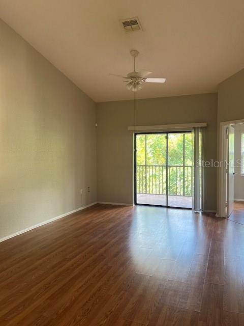 7757 Sugar Bend Drive, Unit 7757 Orlando, FL 32819 - Photo 5 of 30 a view of an empty room with wooden floor and a window