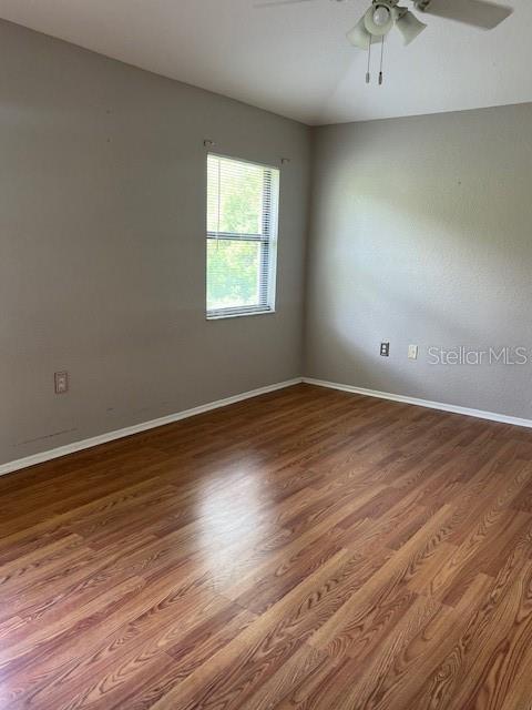 7757 Sugar Bend Drive, Unit 7757 Orlando, FL 32819 - Photo 6 of 30 an empty room with wooden floor and windows