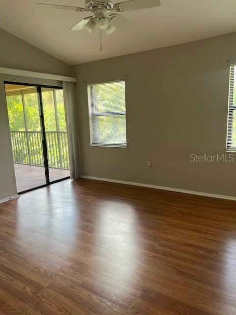 7757 Sugar Bend Drive, Unit 7757 Orlando, FL 32819 - Photo 10 of 30 an empty room with wooden floor and windows