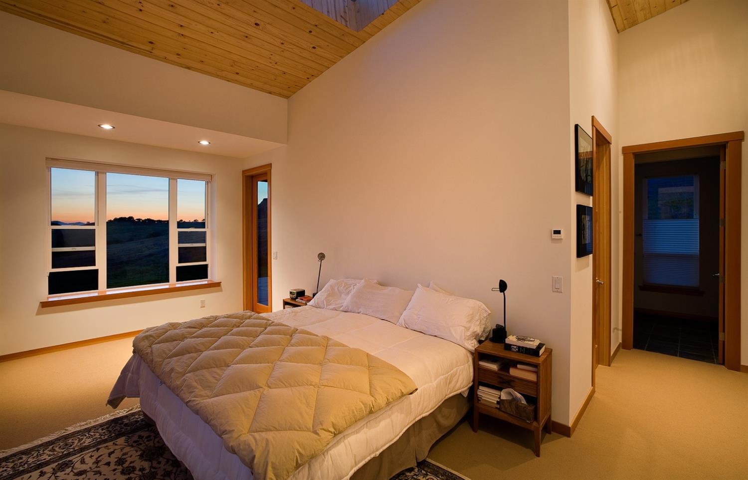 2645 Butler Creek Road Ashland, OR 97520 - Photo 13 of 17 a bedroom with a bed and a large window