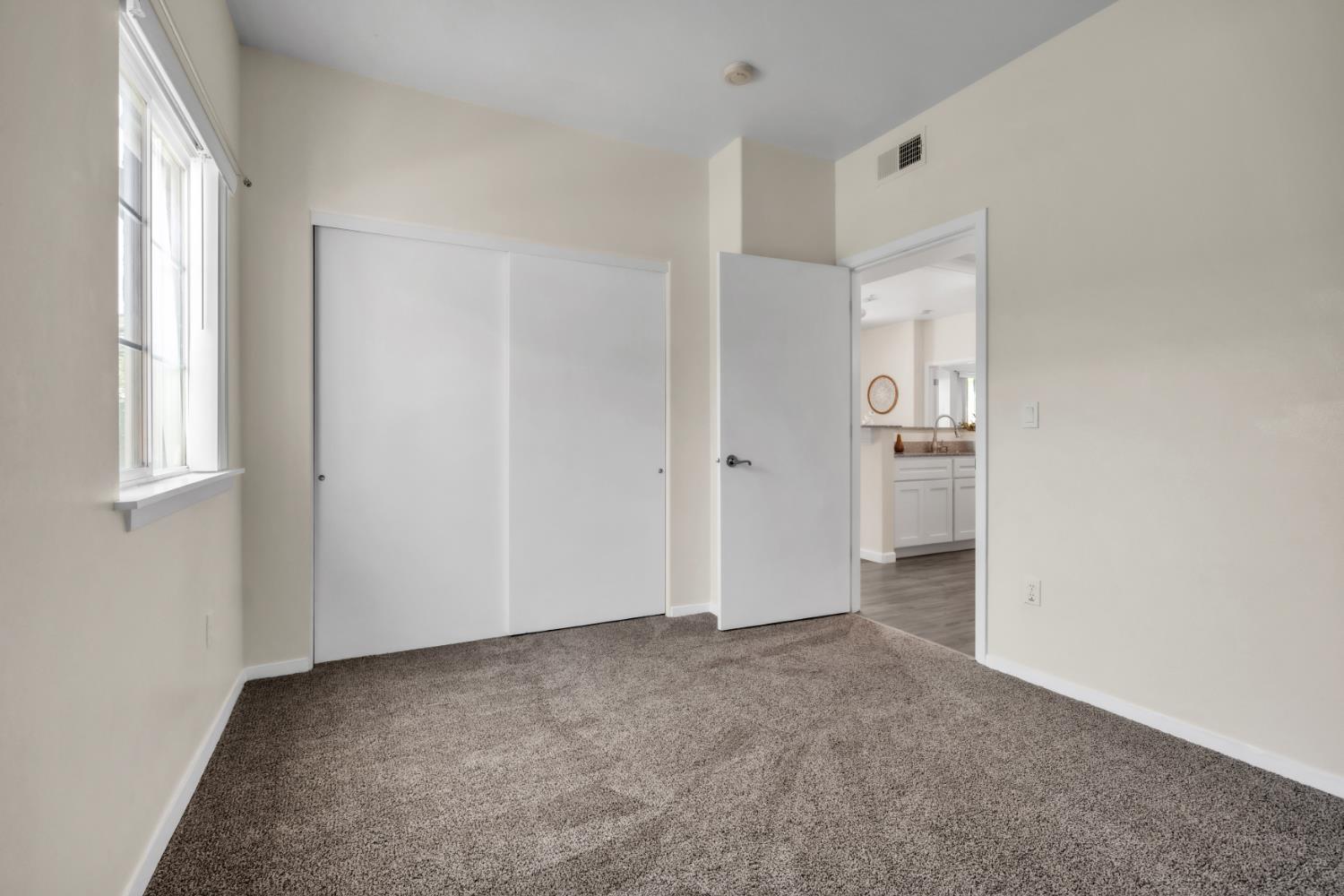 4200 East Commerce Way, Unit 1611 Sacramento, CA 95834 - Photo 11 of 39 an empty room with windows and closet