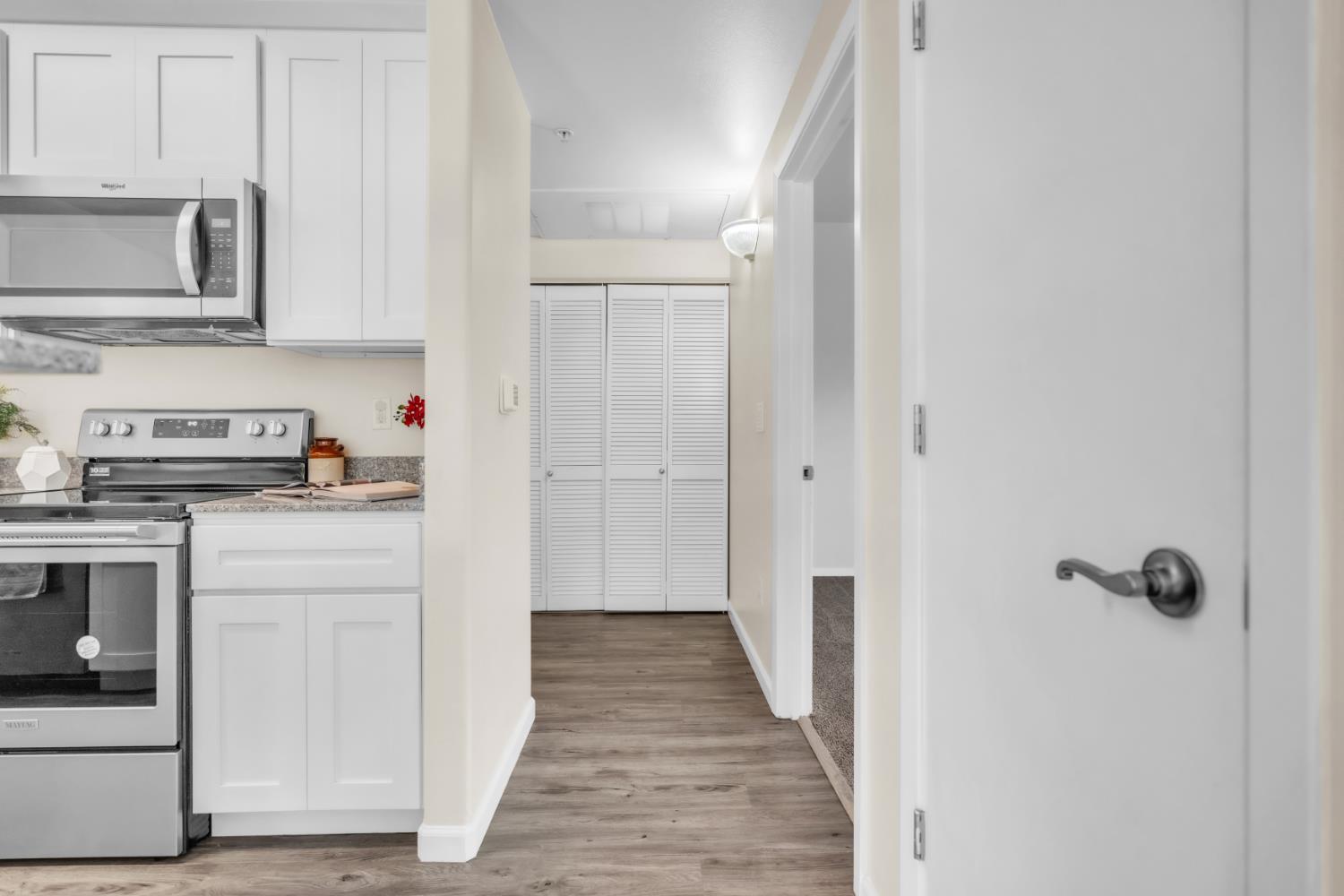 4200 East Commerce Way, Unit 1611 Sacramento, CA 95834 - Photo 12 of 39 a kitchen with white cabinets and appliances