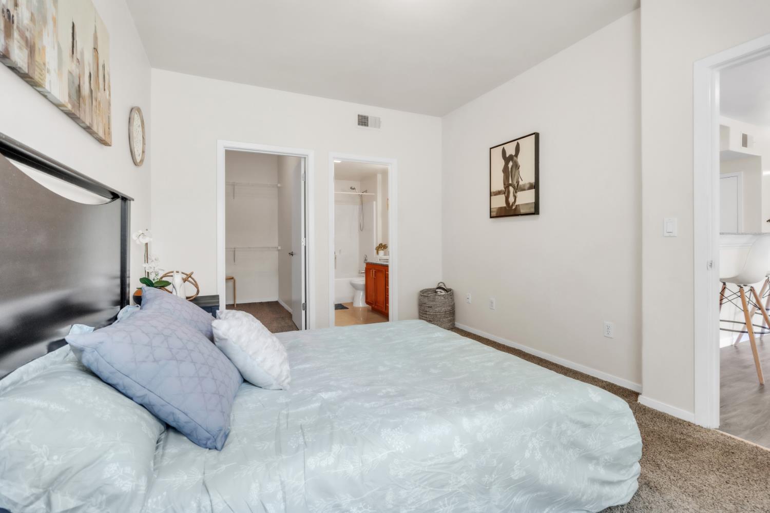 4200 East Commerce Way, Unit 1611 Sacramento, CA 95834 - Photo 17 of 39 a bedroom with a bed and a painting on the wall