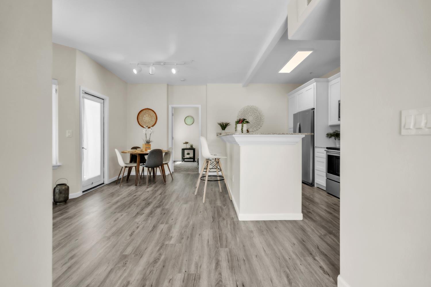 4200 East Commerce Way, Unit 1611 Sacramento, CA 95834 - Photo 3 of 39 a living room with furniture and a wooden floor