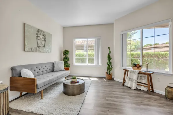 a living room with furniture and a large window