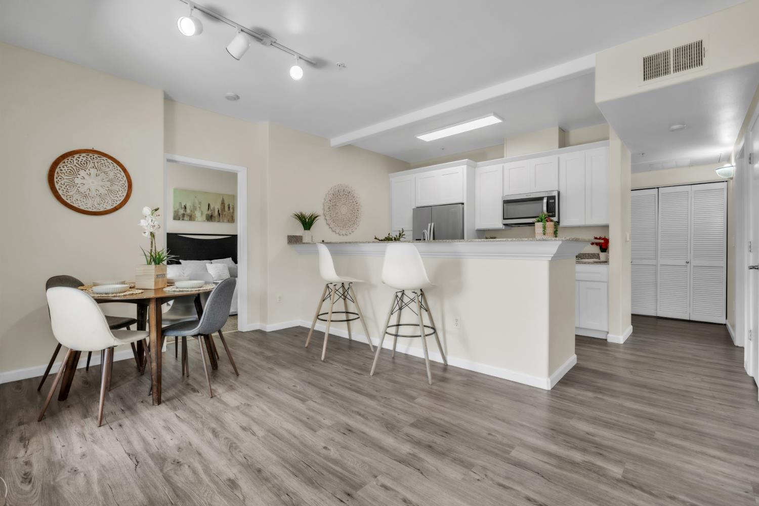 4200 East Commerce Way, Unit 1611 Sacramento, CA 95834 - Photo 6 of 39 a view of kitchen with refrigerator a microwave and wooden floor