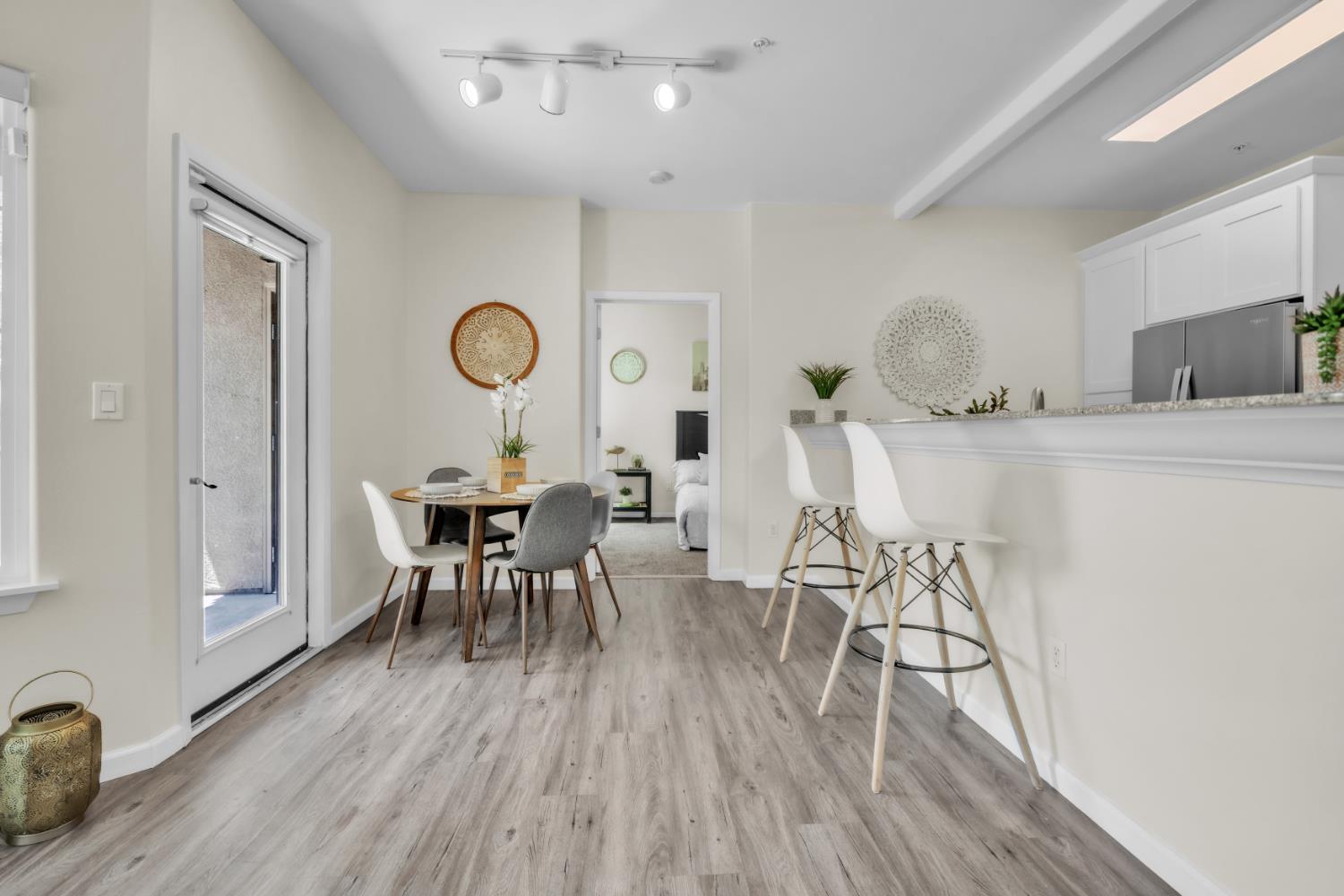 4200 East Commerce Way, Unit 1611 Sacramento, CA 95834 - Photo 7 of 39 a view of a dining room with furniture and wooden floor