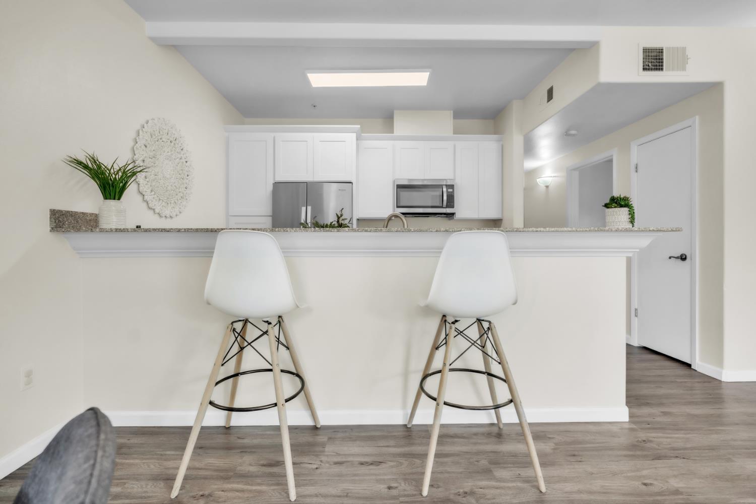 4200 East Commerce Way, Unit 1611 Sacramento, CA 95834 - Photo 8 of 39 a living room with stainless steel appliances furniture a rug and a kitchen view