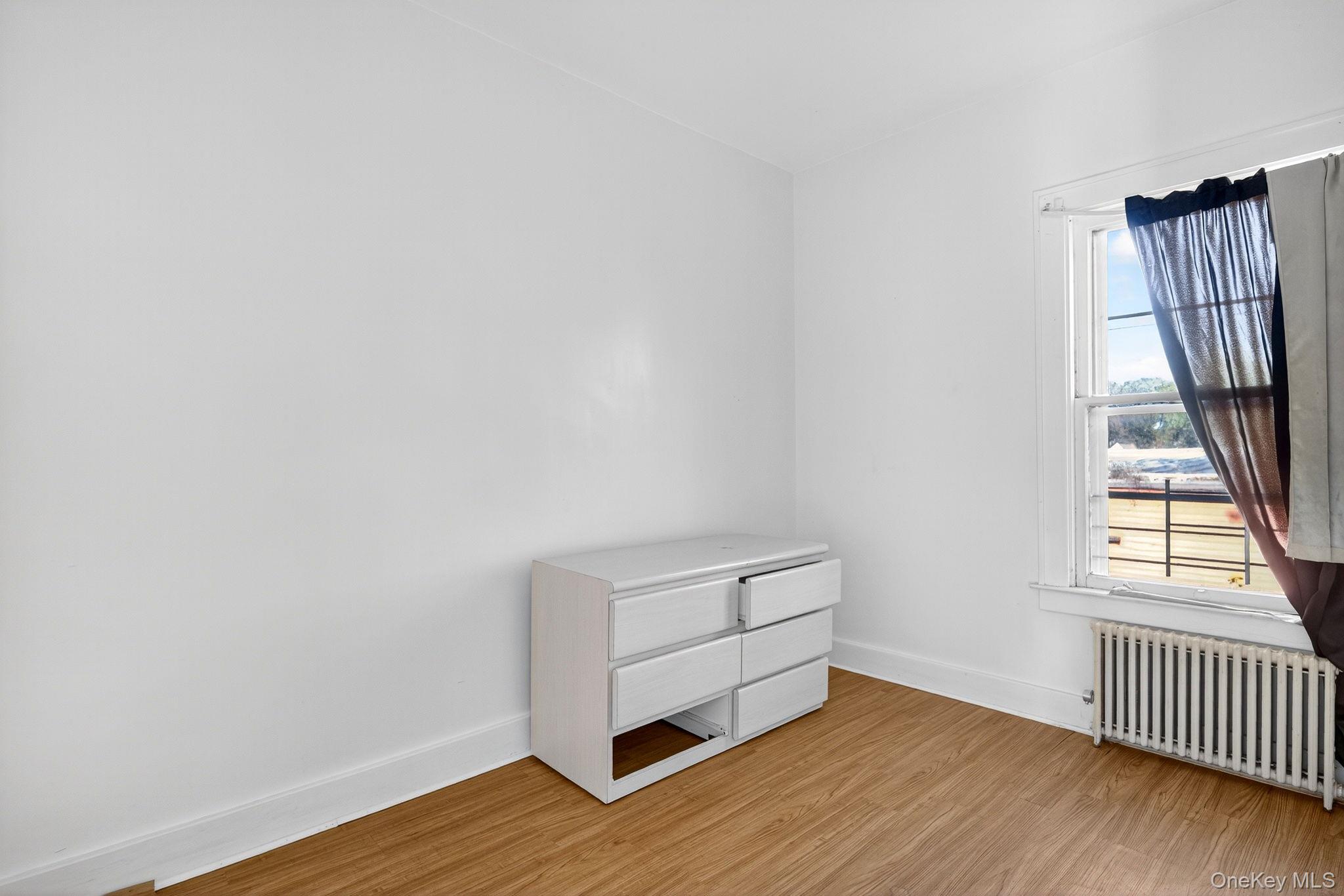 964 State Street Schenectady, NY 12307 - Photo 8 of 24 Unfurnished bedroom featuring radiator heating unit and light wood finished floors