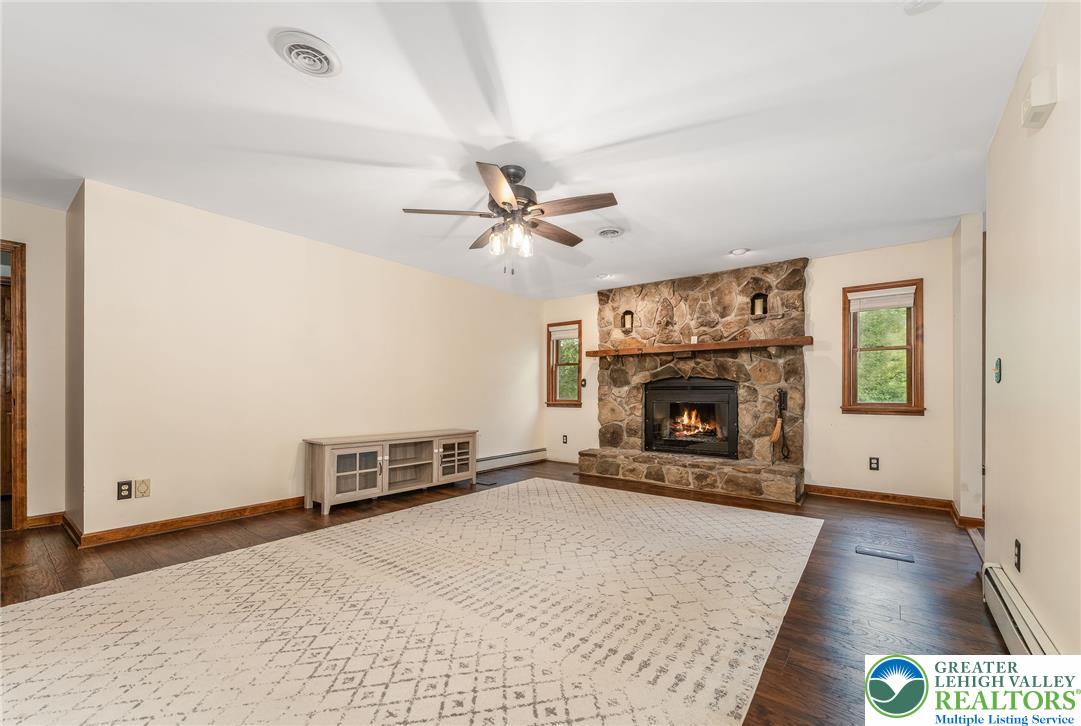 465 Raubsville Road Easton, PA 18042 - Photo 26 of 60 A spacious living area featuring rich Laminate floors and a warm stone fireplace.