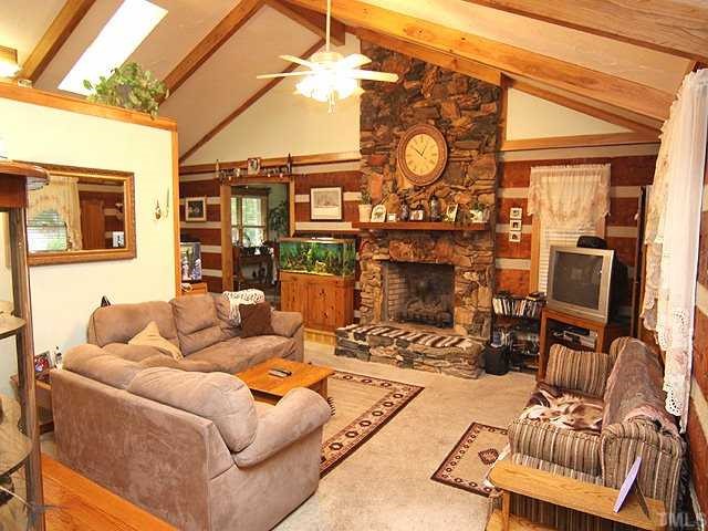 1170 Wrenn Crumpton Road Roxboro, NC 27574 - Photo 2 of 12 a living room with furniture a flat screen tv and a fireplace