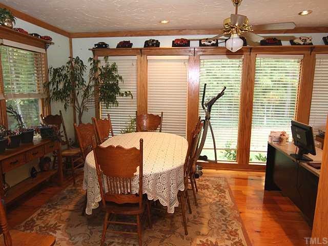 1170 Wrenn Crumpton Road Roxboro, NC 27574 - Photo 4 of 12 a view of a dining room with furniture window and wooden floor