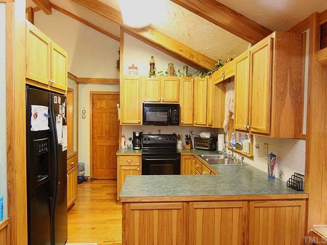 1170 Wrenn Crumpton Road Roxboro, NC 27574 - Photo 5 of 12 a kitchen with a stove a refrigerator and a sink