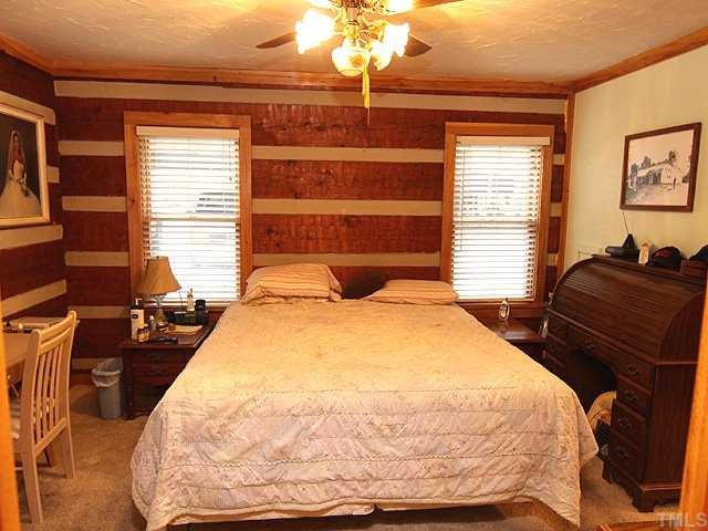 1170 Wrenn Crumpton Road Roxboro, NC 27574 - Photo 6 of 12 a bedroom with a bed and wooden floor