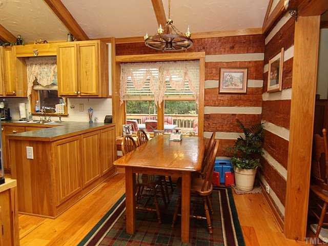 1170 Wrenn Crumpton Road Roxboro, NC 27574 - Photo 7 of 12 a dining room with furniture a window and a chandelier