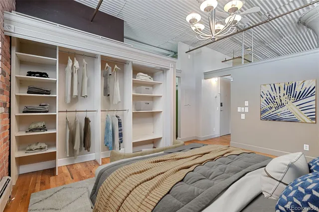 a bedroom with a bed and a chandelier