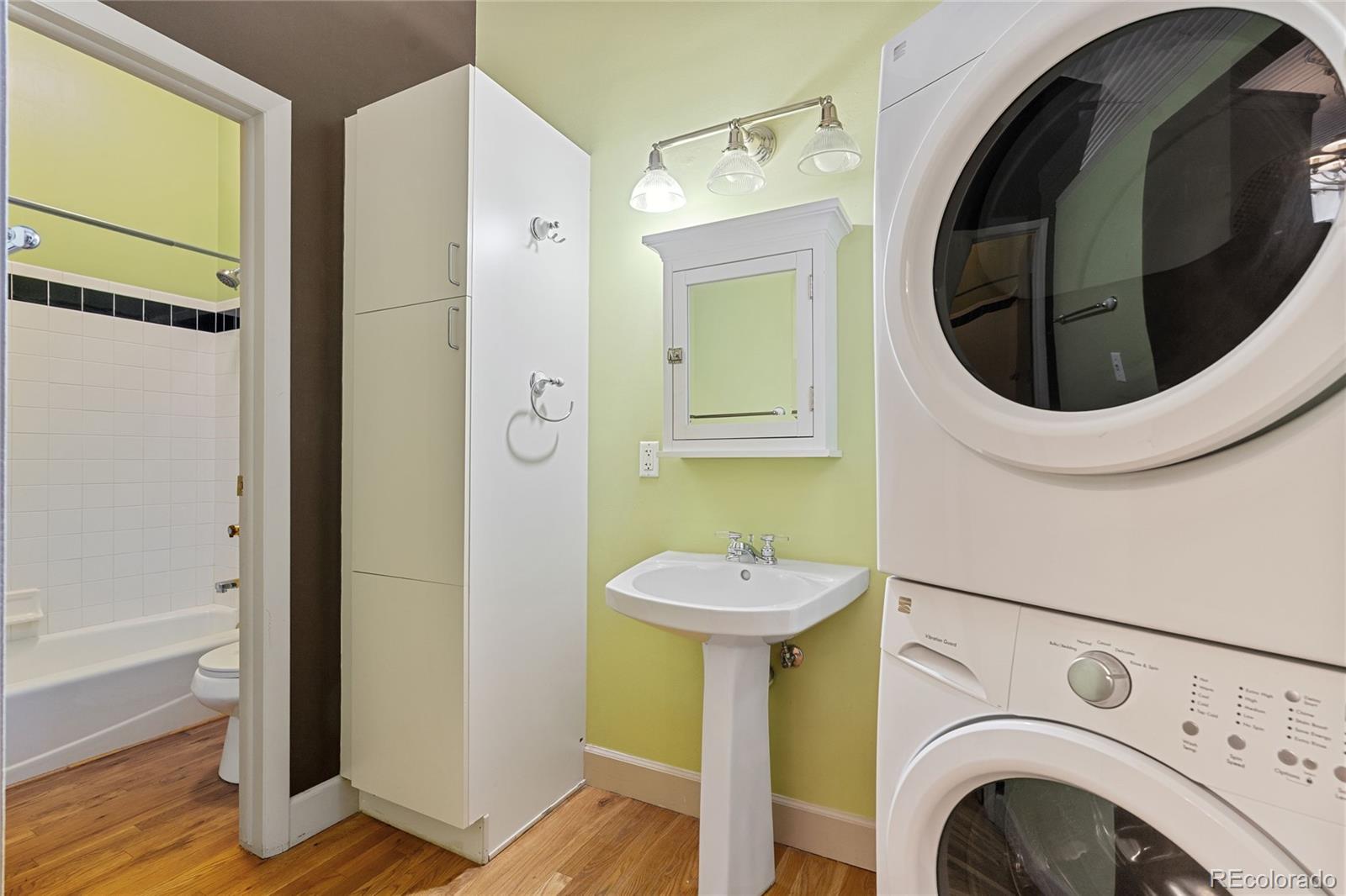 2261 Blake Street, Unit 4D Denver, CO 80205 - Photo 5 of 15 a bathroom with a sink and a mirror