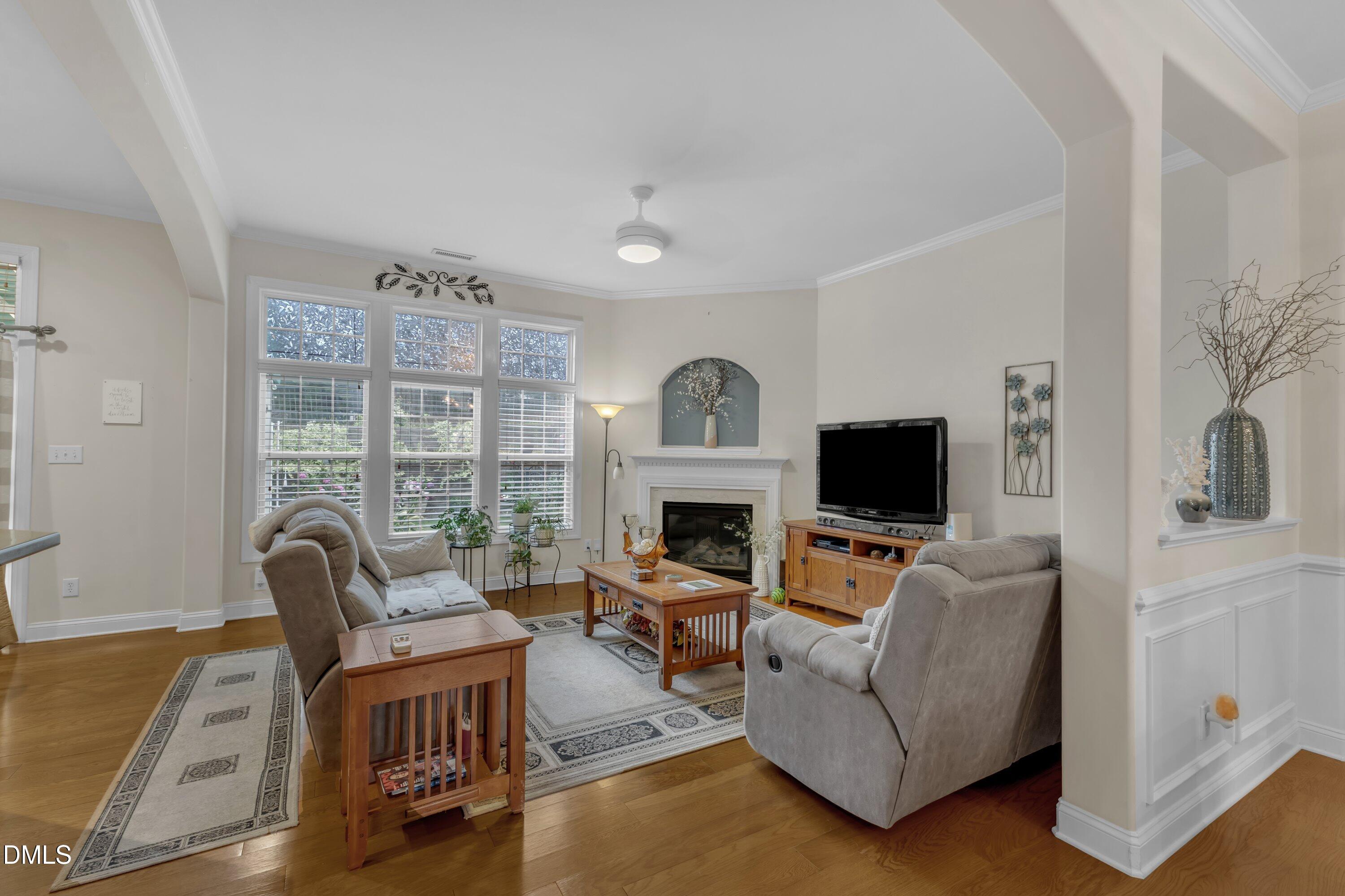 12227 Orchardgrass Lane Raleigh, NC 27614 - Photo 12 of 46 a living room with furniture a fireplace and a flat screen tv