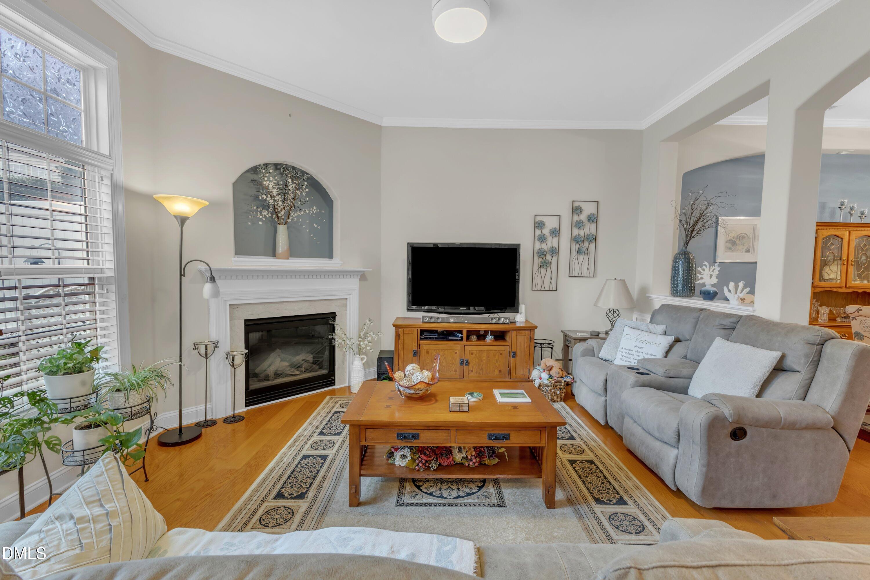 12227 Orchardgrass Lane Raleigh, NC 27614 - Photo 14 of 46 a living room with furniture or flat screen tv and a fireplace