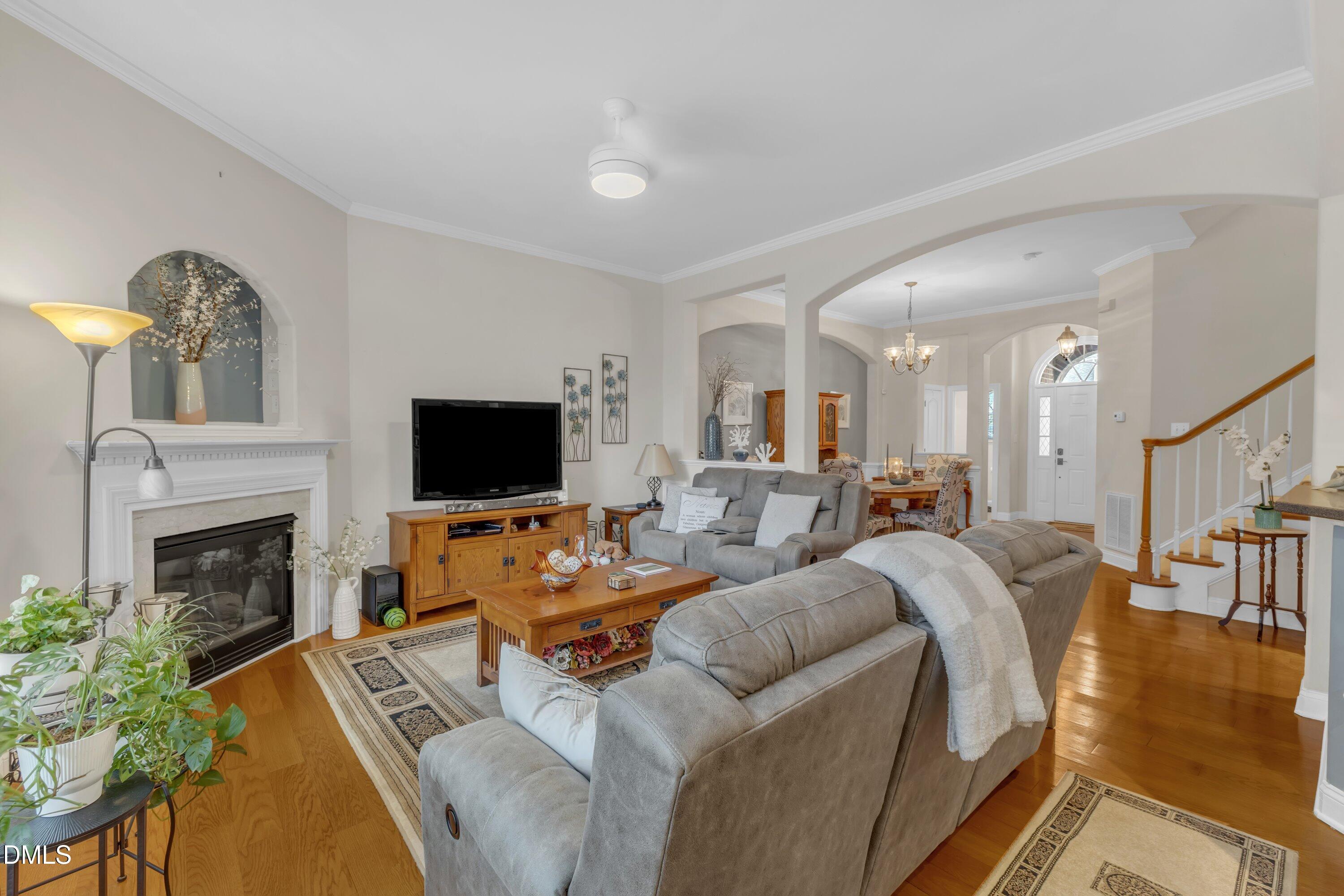 12227 Orchardgrass Lane Raleigh, NC 27614 - Photo 15 of 46 a living room with furniture a fireplace and a flat screen tv
