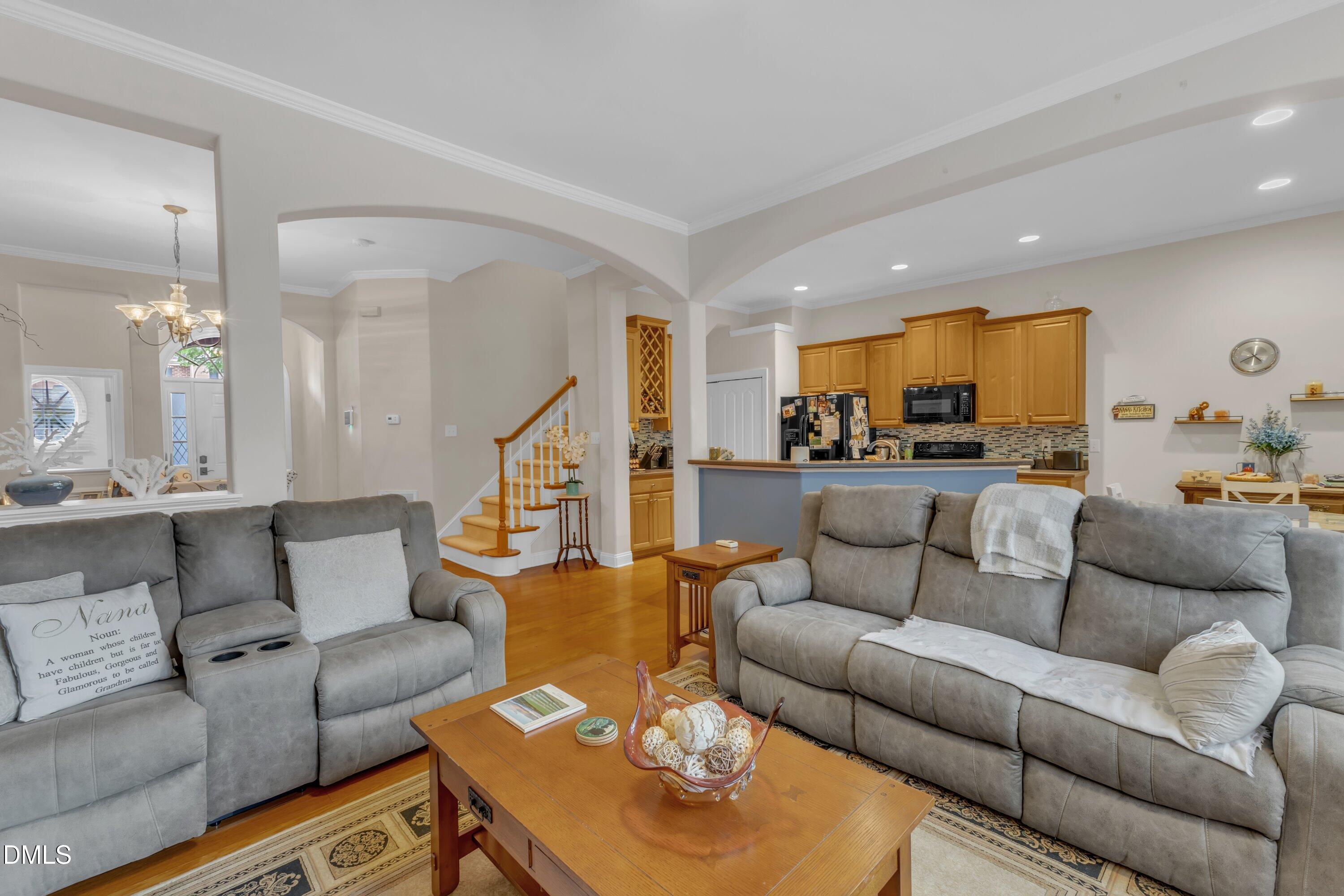 12227 Orchardgrass Lane Raleigh, NC 27614 - Photo 16 of 46 a living room with furniture kitchen view and a wooden floor