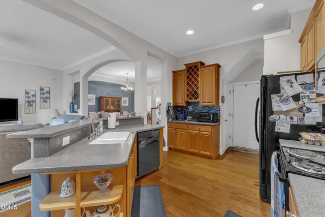 a kitchen with granite countertop a sink a counter top space and stainless steel appliances