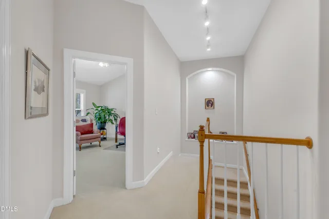 a living room with furniture a window and a potted plant