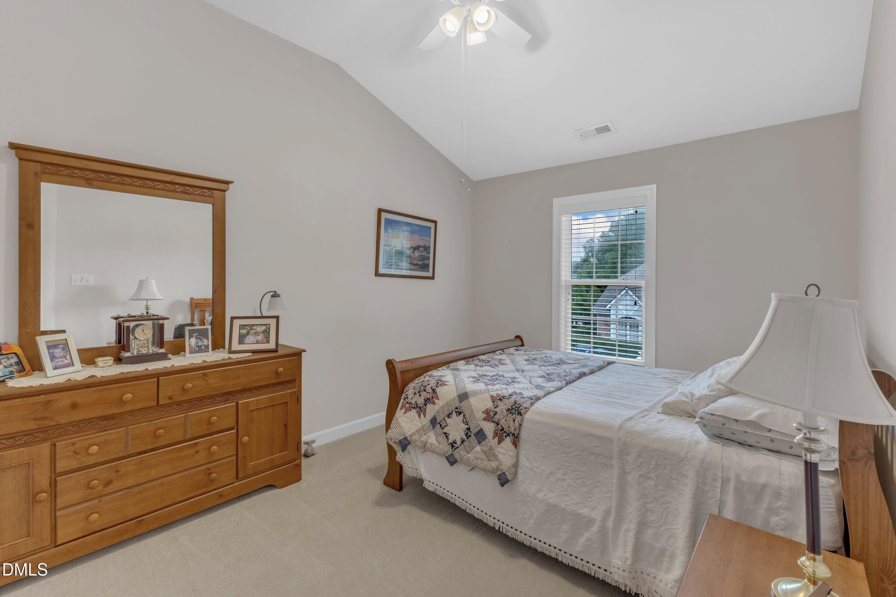 12227 Orchardgrass Lane Raleigh, NC 27614 - Photo 28 of 46 a bedroom with a bed and a dresser