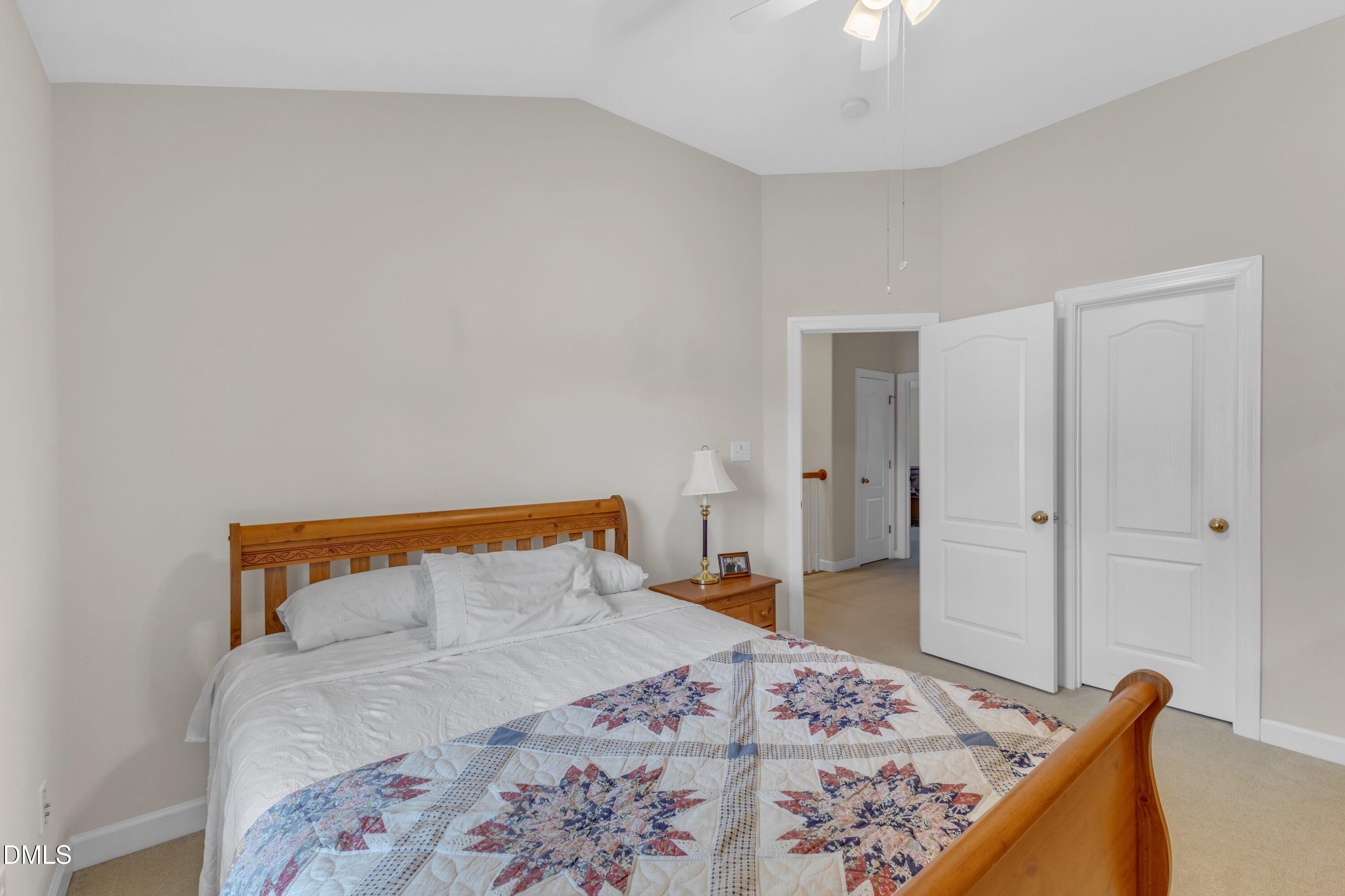 12227 Orchardgrass Lane Raleigh, NC 27614 - Photo 30 of 46 a bedroom with a bed and a dresser
