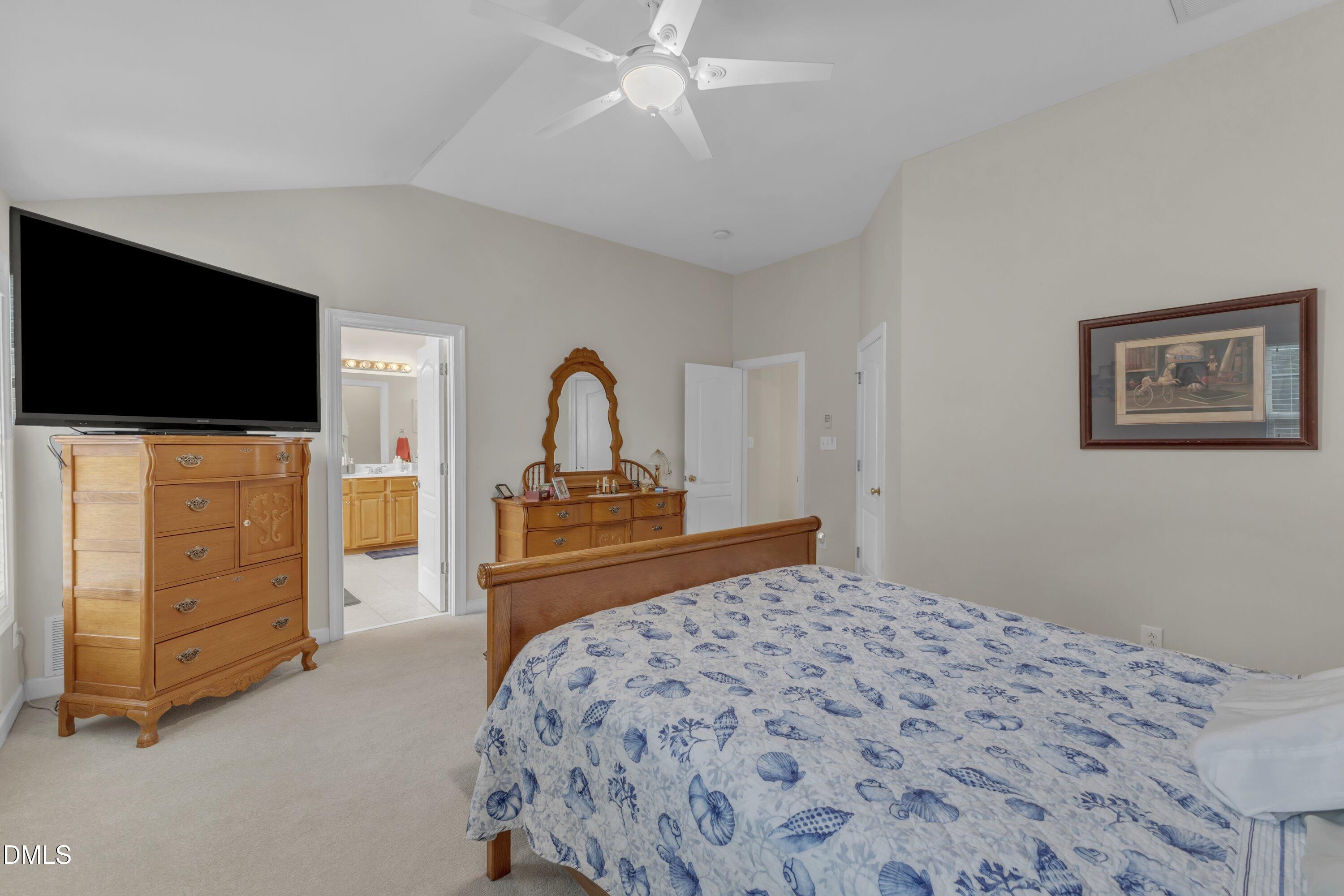 12227 Orchardgrass Lane Raleigh, NC 27614 - Photo 36 of 46 a bedroom with a bed and a flat screen tv